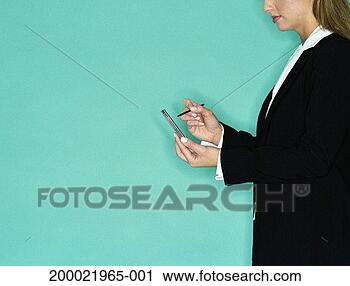 Stock Photography - young woman using 
palmtop computer, 
profile. fotosearch 
- search stock 
photos, pictures, 
images, and photo 
clipart