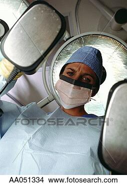Stock Photo - young female surgeon 
holding defibrillator, 
low angle view. 
fotosearch - search 
stock photos, 
pictures, images, 
and photo clipart