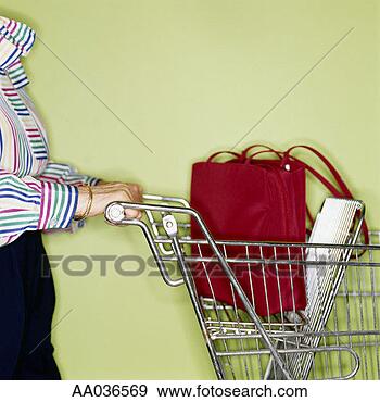 Stock Photograph - elderly woman 
pushing a shopping 
cart. fotosearch 
- search stock 
photos, pictures, 
images, and photo 
clipart