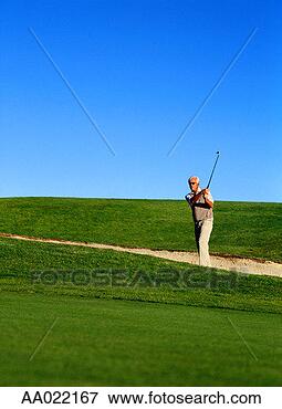 Picture - man swinging out 
of a bunker. fotosearch 
- search stock 
photos, pictures, 
images, and photo 
clipart