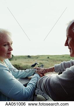 Stock Photo - senior couple, 
gazing at eachother 
holding hands. 
fotosearch - search 
stock photos, 
pictures, images, 
and photo clipart