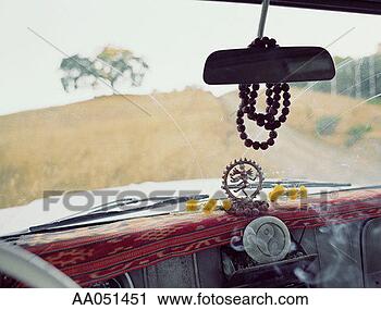 Stock Photography - hindu figure and 
yin yang symbol 
on dashboard of 
car. fotosearch 
- search stock 
photos, pictures, 
images, and photo 
clipart