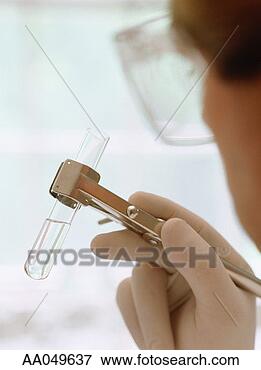 Picture - scientist holding 
test tube in clamp. 
fotosearch - search 
stock photos, 
pictures, images, 
and photo clipart