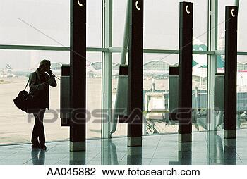 Stock Photo - businesswoman 
on pay phone at 
airport. fotosearch 
- search stock 
photos, pictures, 
images, and photo 
clipart