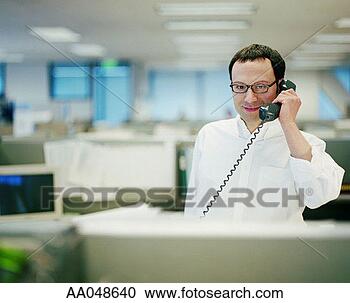 Stock Photography - man using telephone 
in office. fotosearch 
- search stock 
photos, pictures, 
images, and photo 
clipart