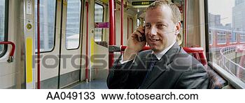 Stock Photo - portrait of a 
man on a mobile 
phone in a passenger 
train. fotosearch 
- search stock 
photos, pictures, 
images, and photo 
clipart