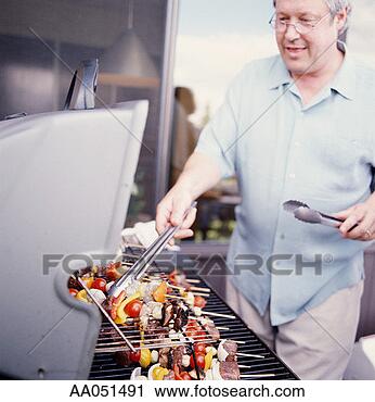 Stock Photography - man grilling kebabs 
on barbecue grill. 
fotosearch - search 
stock photos, 
pictures, images, 
and photo clipart
