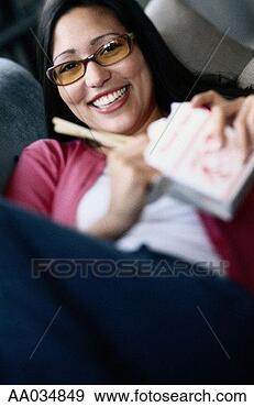 Stock Photograph - woman eating chinese 
food, smiling 
(focus on face). 
fotosearch - search 
stock photos, 
pictures, images, 
and photo clipart