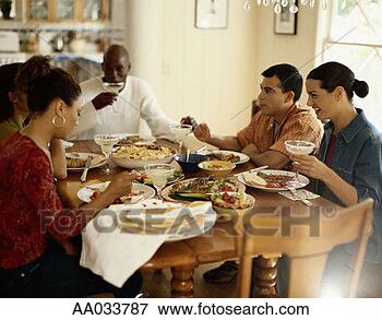 Picture - young adults eating 
dinner. fotosearch 
- search stock 
photos, pictures, 
images, and photo 
clipart