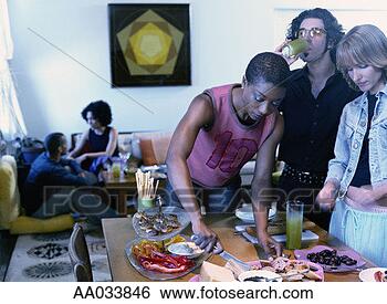 Stock Photo - young adults at 
small party, nyc 
loft. fotosearch 
- search stock 
photos, pictures, 
images, and photo 
clipart