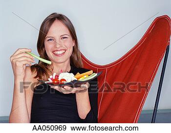 Stock Photograph - young woman holding 
plate of vegetables, 
portrait. fotosearch 
- search stock 
photos, pictures, 
images, and photo 
clipart