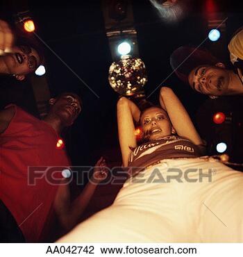 Stock Photo - group of young 
people dancing 
at nightclub, 
low angle view. 
fotosearch - search 
stock photos, 
pictures, images, 
and photo clipart