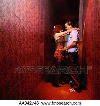 Stock Photo - young couple having 
an intimate moment 
in nightclub hallway. 
fotosearch - search 
stock photos, 
pictures, images, 
and photo clipart