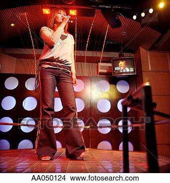 Stock Photo - young woman on 
singing at karaoke 
bar. fotosearch 
- search stock 
photos, pictures, 
images, and photo 
clipart
