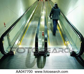 Stock Photography - woman with shopping 
cart on escalator, 
rear view blurred 
motion. fotosearch 
- search stock 
photos, pictures, 
images, and photo 
clipart