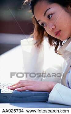 Stock Photo - young woman using 
laptop computer. 
fotosearch - search 
stock photos, 
pictures, images, 
and photo clipart