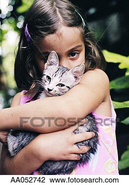 Stock Photo - girl (6-8) embracing 
cat (selective 
focus). fotosearch 
- search stock 
photos, pictures, 
images, and photo 
clipart