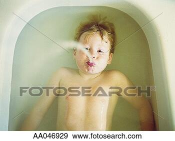Stock Photograph - boy (5-7) spitting 
water while lying 
in bath, overhead 
view. fotosearch 
- search stock 
photos, pictures, 
images, and photo 
clipart