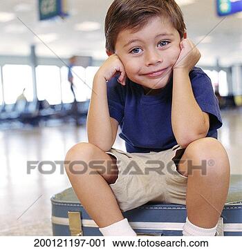 Stock Photography - boy (2-4) sitting 
on suitcase at 
airport, portrait. 
fotosearch - search 
stock photos, 
pictures, images, 
and photo clipart