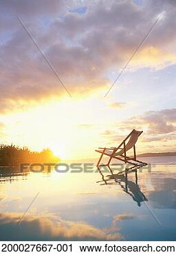 Stock Photography - deckchair on beach, 
sunset. fotosearch 
- search stock 
photos, pictures, 
images, and photo 
clipart