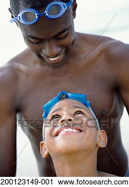 Stock Photography - father and son 
(6-8)wearing swimming 
goggles on heads, 
close-up. fotosearch 
- search stock 
photos, pictures, 
images, and photo 
clipart