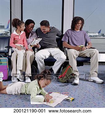 Stock Photography - mother, father, 
and three children 
(6-17) sitting 
in airport. fotosearch 
- search stock 
photos, pictures, 
images, and photo 
clipart
