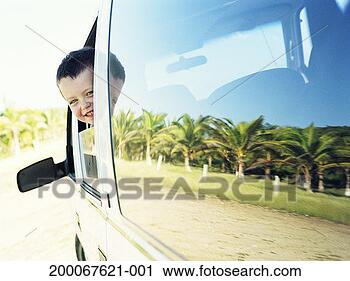 Stock Photography - young boy (4-6) 
peaking head out 
of car window. 
fotosearch - search 
stock photos, 
pictures, images, 
and photo clipart