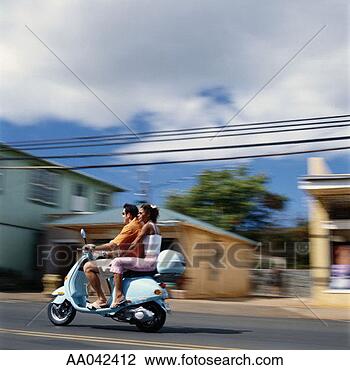 Stock Photo - young couple on 
motor scooter, 
side view (blurred 
motion). fotosearch 
- search stock 
photos, pictures, 
images, and photo 
clipart