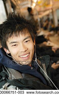 Stock Photo - teenage boy (16-18) 
wearing headphones, 
smiling, portrait, 
close up. fotosearch 
- search stock 
photos, pictures, 
images, and photo 
clipart