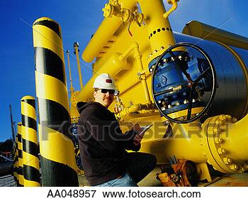 Picture - man using clipboard 
near pipes at 
natural gas plant, 
portait. fotosearch 
- search stock 
photos, pictures, 
images, and photo 
clipart