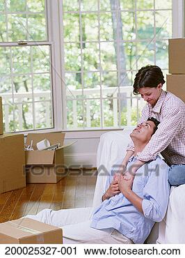 Stock Photography - couple hugging, 
surrounded by 
moving boxes, 
interior of new 
house. fotosearch 
- search stock 
photos, pictures, 
images, and photo 
clipart