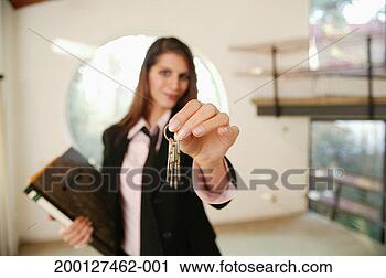 Stock Photography - young woman holding 
keys (focus on 
keys). fotosearch 
- search stock 
photos, pictures, 
images, and photo 
clipart