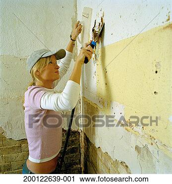 Stock Photography - young woman using 
wallpaper strippers, 
side view. fotosearch 
- search stock 
photos, pictures, 
images, and photo 
clipart