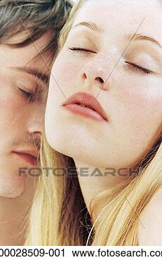 Stock Photography - intimate young 
couple, eyes closed, 
close-up. fotosearch 
- search stock 
photos, pictures, 
images, and photo 
clipart