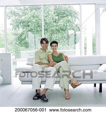 Stock Photography - mature couple 
sitting on couch 
together, portrait. 
fotosearch - search 
stock photos, 
pictures, images, 
and photo clipart