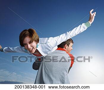 Stock Photography - young man carrying 
young woman over 
his shoulder. 
fotosearch - search 
stock photos, 
pictures, images, 
and photo clipart