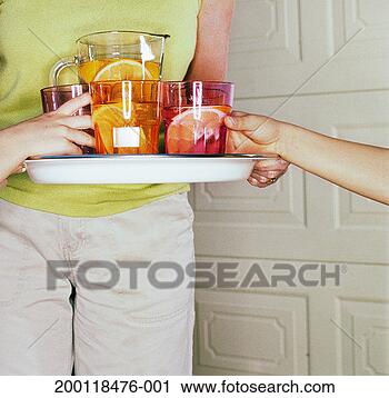 Stock Photography - boy (7-9) and 
girl (5-7) taking 
drinks from tray 
held by woman. 
fotosearch - search 
stock photos, 
pictures, images, 
and photo clipart