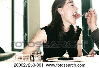 Stock Photography - couple in cafe, 
man holding fork 
of dessert to 
woman's mouth. 
fotosearch - search 
stock photos, 
pictures, images, 
and photo clipart