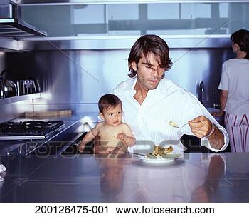 Stock Photography - father holding 
baby girl (6-9 
months) and fork 
of food. fotosearch 
- search stock 
photos, pictures, 
images, and photo 
clipart