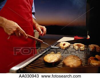 Stock Photo - man grilling fish 
on a barbeque. 
fotosearch - search 
stock photos, 
pictures, images, 
and photo clipart