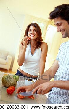 Stock Photography - young couple in 
kitchen, man slicing 
tomatoes. fotosearch 
- search stock 
photos, pictures, 
images, and photo 
clipart