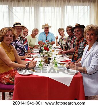 Stock Photography - group of mature 
people at dinner 
table smiling, 
portrait. fotosearch 
- search stock 
photos, pictures, 
images, and photo 
clipart
