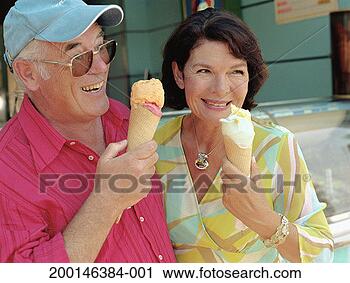 Stock Photography - mature couple 
holding ice creams, 
smiling. fotosearch 
- search stock 
photos, pictures, 
images, and photo 
clipart
