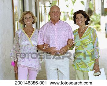 Stock Photography - mature man and 
two mature women 
linking arms outdoors, 
portrait. fotosearch 
- search stock 
photos, pictures, 
images, and photo 
clipart