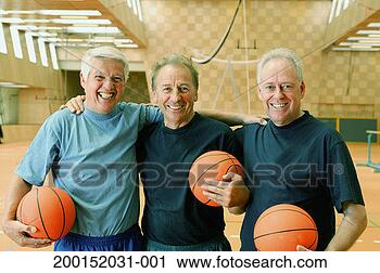 Stock Photography - three mature men 
holding basketballs 
in gymnasium, 
smiling, portrait. 
fotosearch - search 
stock photos, 
pictures, images, 
and photo clipart