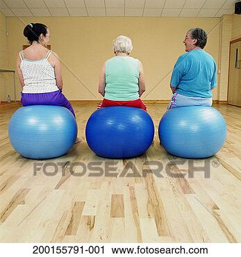 Stock Photography - three mature women 
sitting on exercise 
balls, in gym 
studio, rear view. 
fotosearch - search 
stock photos, 
pictures, images, 
and photo clipart