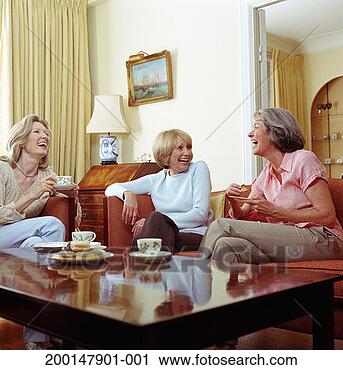 Stock Photography - three senior women 
in living room 
having afternoon 
tea, laughing. 
fotosearch - search 
stock photos, 
pictures, images, 
and photo clipart