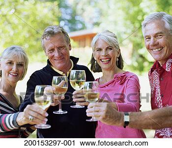 Stock Photography - two mature couples 
drinking white 
wine, smiling, 
portrait. fotosearch 
- search stock 
photos, pictures, 
images, and photo 
clipart