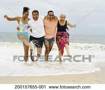 Stock Photography - two mature couples 
running in surf 
at water's edge. 
fotosearch - search 
stock photos, 
pictures, images, 
and photo clipart