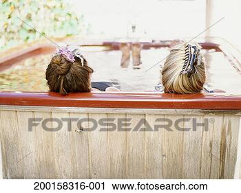 Stock Photography - two mature women 
soaking in hot 
tub, rear view. 
fotosearch - search 
stock photos, 
pictures, images, 
and photo clipart